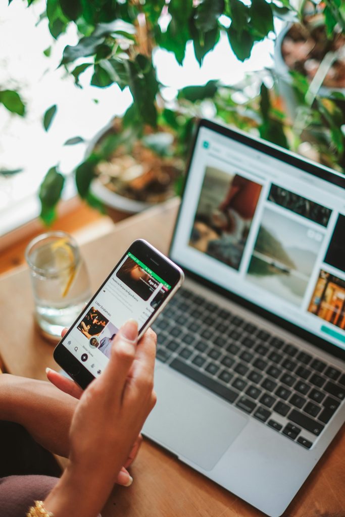 pexels photo 17774938 17774938 A cozy workspace featuring a smartphone and laptop used for social networking surrounded by greenery.